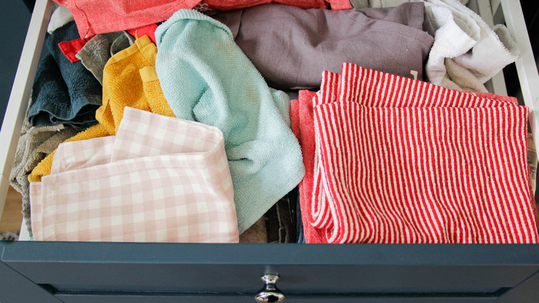 Cleaning towels in a messy jumble in a kitchen drawer