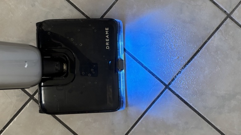 A Dreame Aero Ultra Steam Vacuum Mop in use angled towards a pile of cat litter