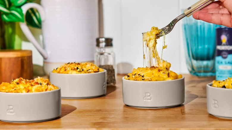 Four small bowls containing pasta.