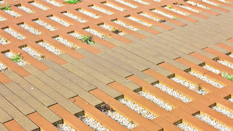 Permeable interlocking concrete pavers usd in a driveway with gravel