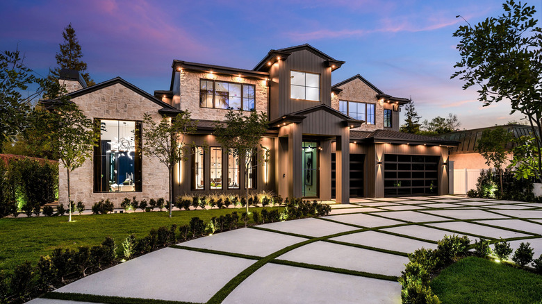 A luxury home with a divided concrete driveway