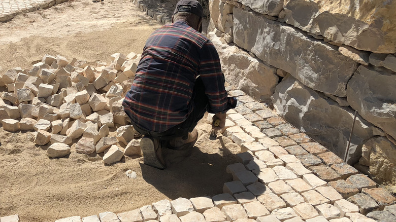 A stone driveway is in the process of being installed