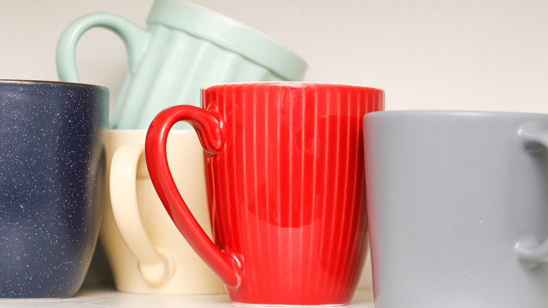 mugs stacked on shelf