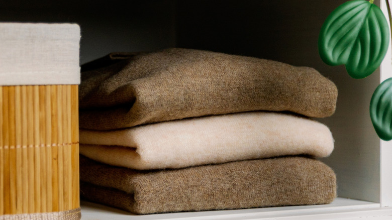 A pile of knitted sweaters