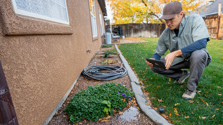 Man inspecting home foundation