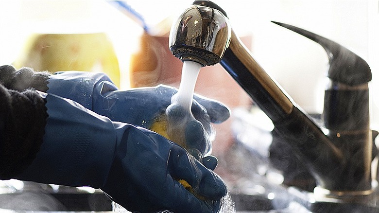 Rinsing gloved hands with water
