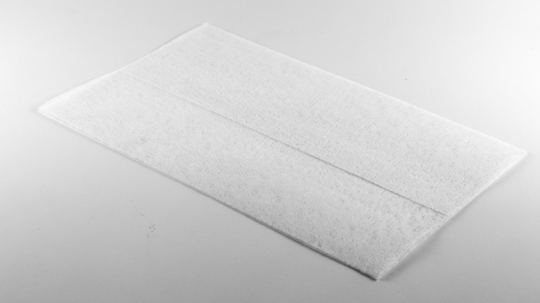 hand grabbing new dryer sheet