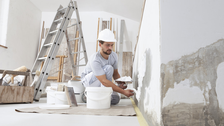 a worker plastering the wall