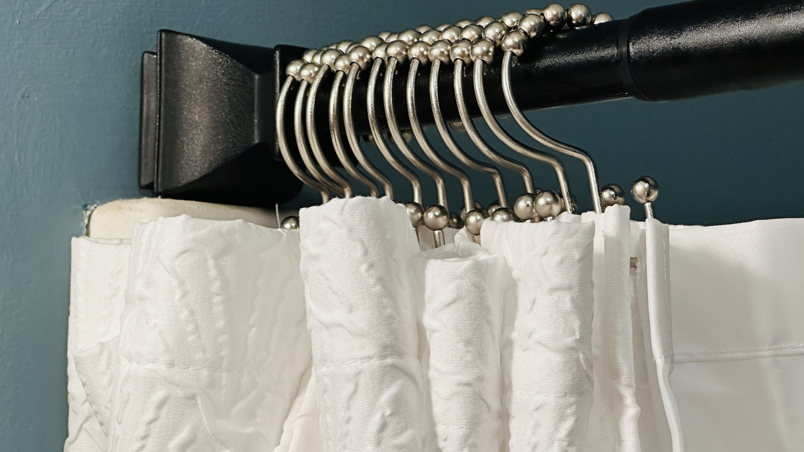 Dump Your Billowy Bathtub Curtain For A Stylish, Space-Saving Alternative From Amazon
