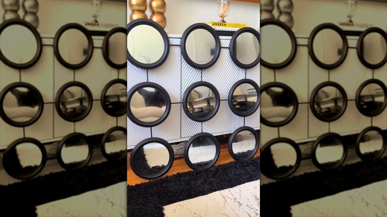 A finished nine-piece accent wall mirror display using Dollar Tree mirrors