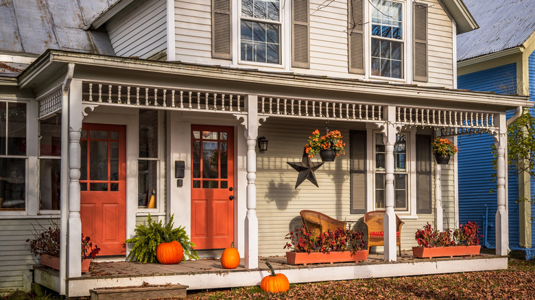 A front porch with some fall decorations