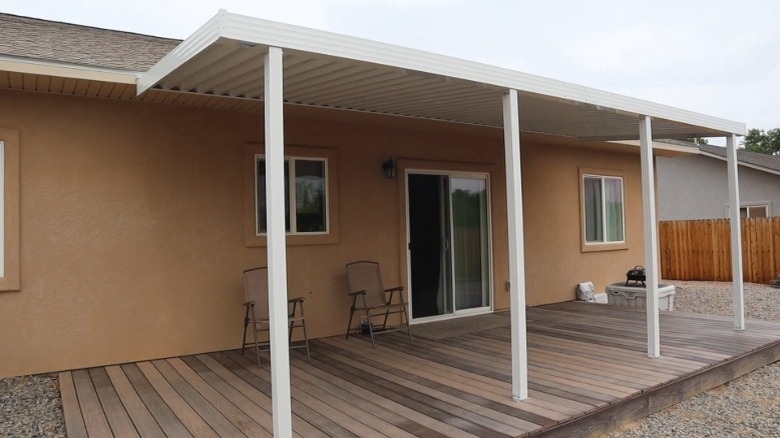 Home with white corrugated aluminum patio awning