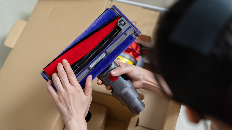 Person unboxing a new vacuum