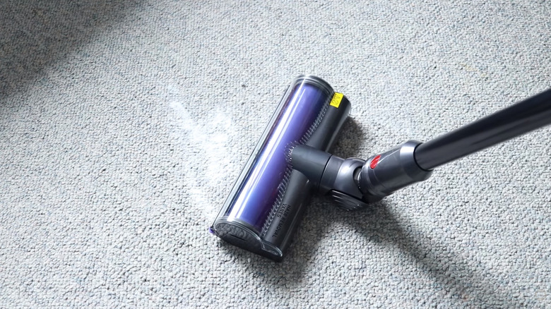 Dyston cordless stick vacuum cleaning white powder on carpet