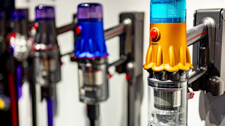 A lineup of Dyson stick vacuums on display at show