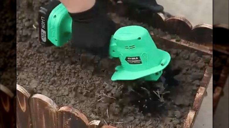 Muylux Cordless Tiller working through soil