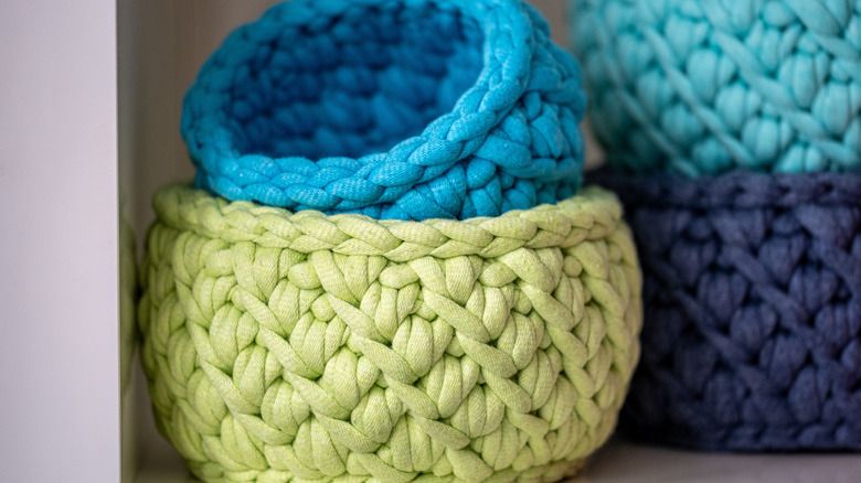 blue and green woven baskets on shelf