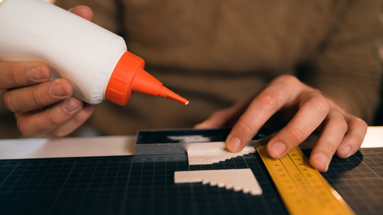 applying glue to wood block 