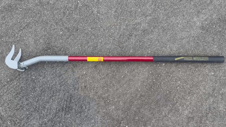 The Original Deck Board Removal Tool by Duckbill Deck Wrecker lying on gravel