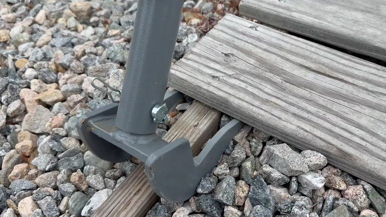 The Original Deck Board Removal Tool by Duckbill Deck Wrecker being used to lift up boards