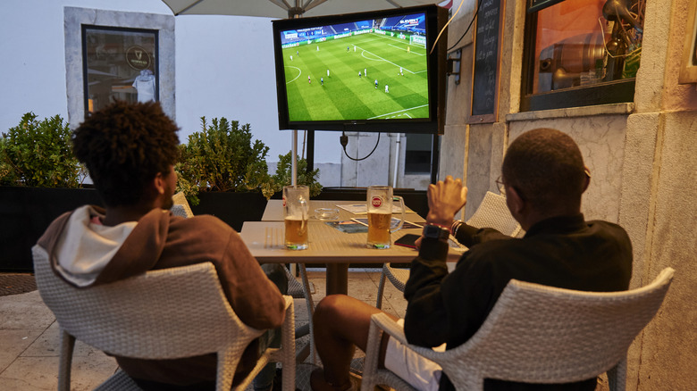 People sitting and watching television