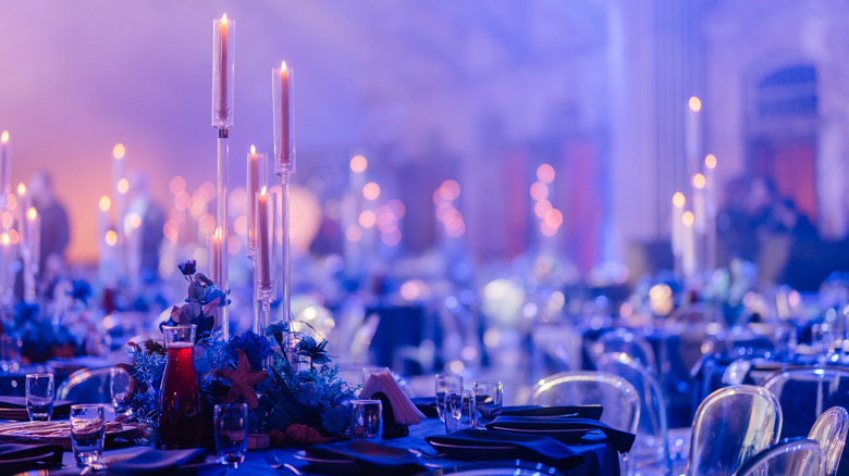 Tall centerpiece in the middle of a formal table
