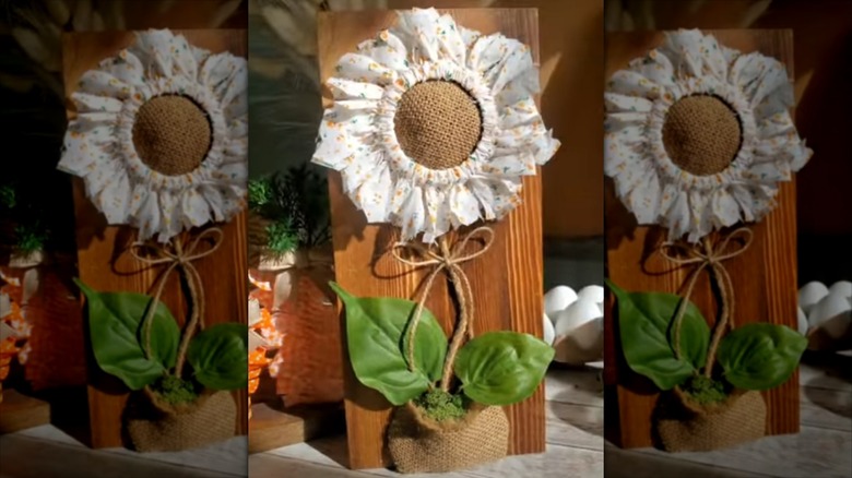 outdoor decor flower made from a mason jar lid, fabric, and burlap sack on a wood background
