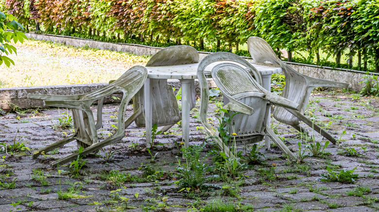 Dirty plastic patio furniture sitting outside