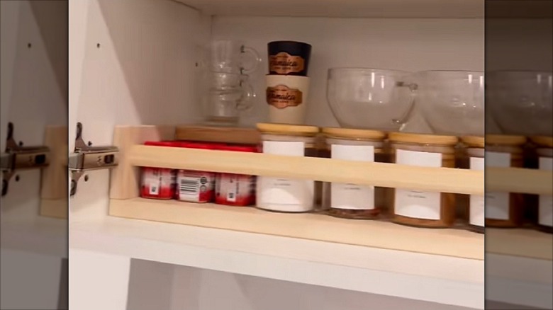 A coffee and tea station inside a kitchen cabinet