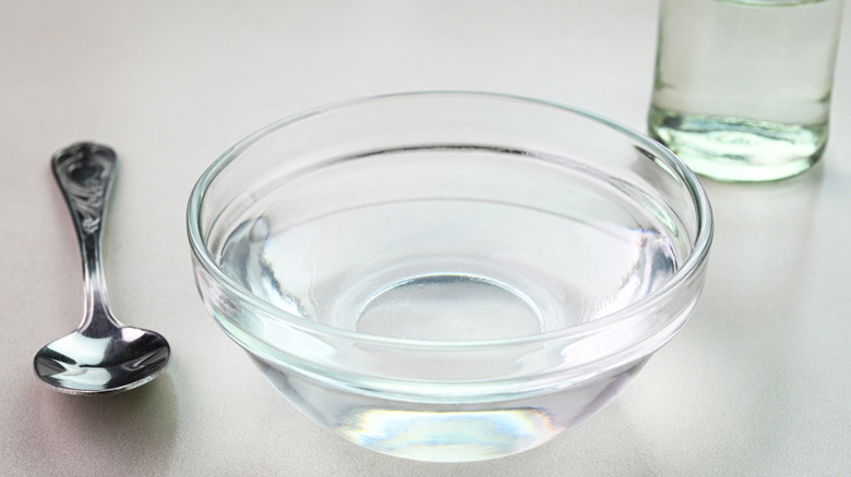 A closeup view of white vinegar in a bowl
