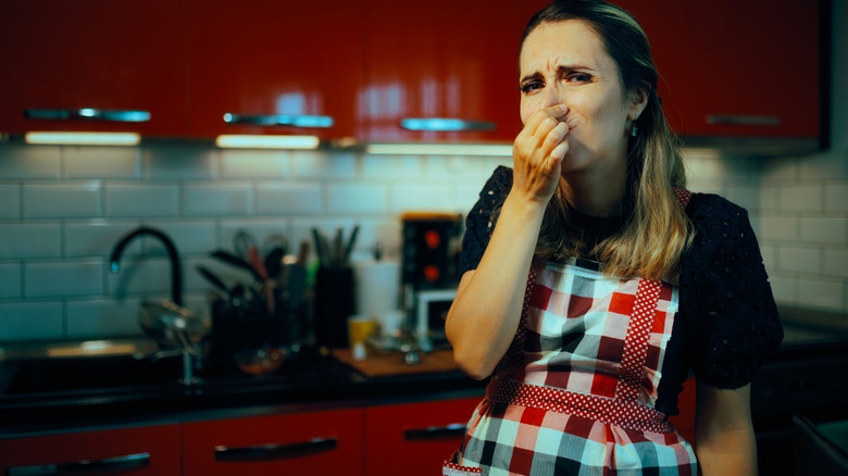 A woman unhappy about the smell in her kitchen