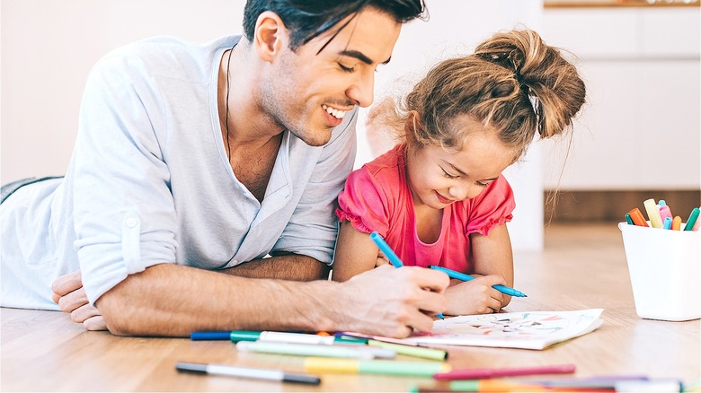 Dad, child playing with markers