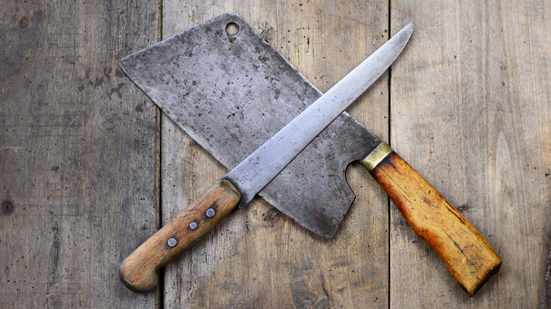 Two kitchen knives against wood background