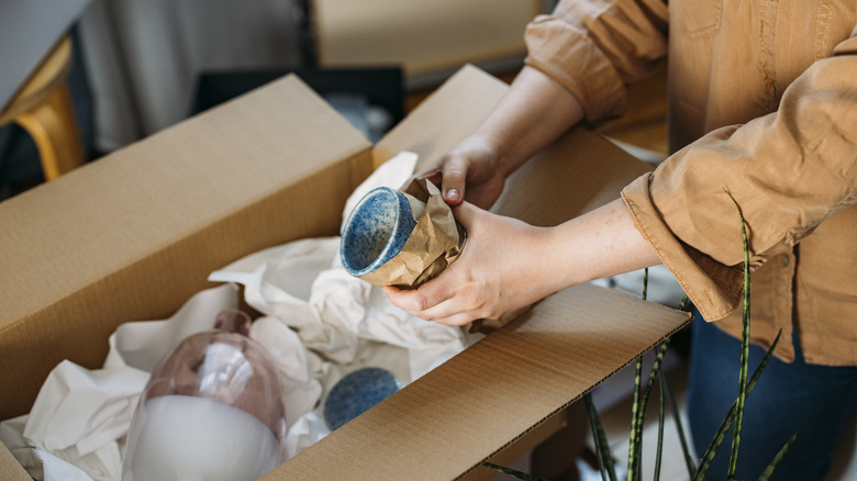 Woman unpacking moving box