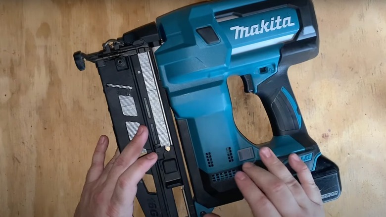 A Makita finish nailer sitting on a wood surface