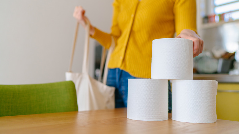 putting toilet rolls on table