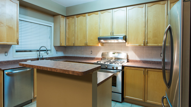 Dated kitchen with wooden cabinets