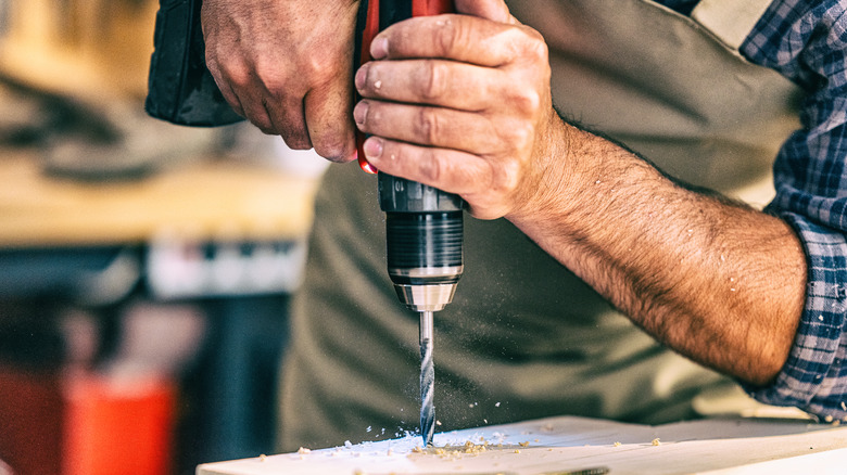 man using a power drill