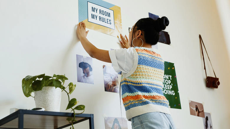 person hanging up poster