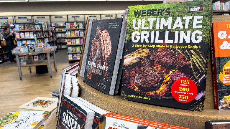 Display of books at a Barnes and Noble with a sticker on a Weber's Ultimate Grilling book