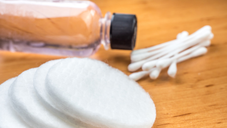 nail polish with q-tips and cotton pads on a table