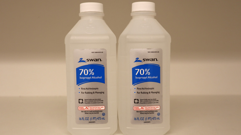 Two bottles of Swan isopropyl alcohol on a table