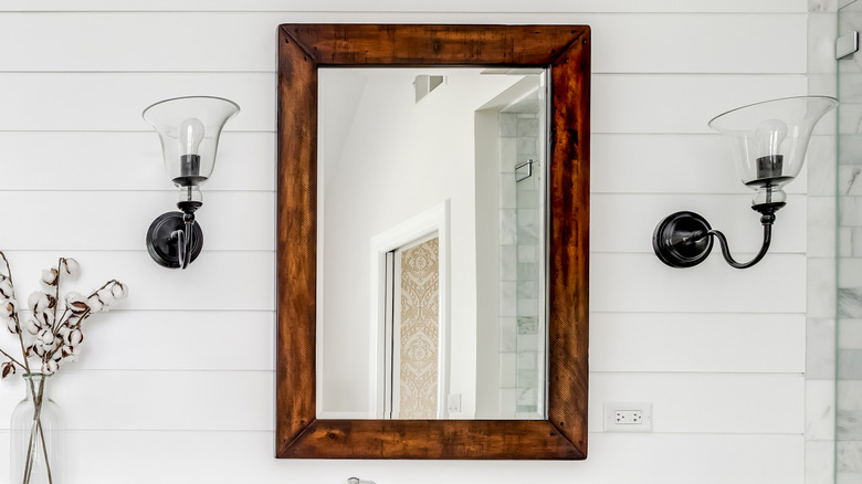 Wooden frame around bathroom mirror