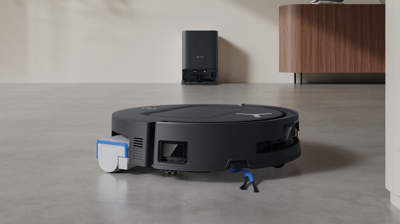 An ECOVACS floor cleaner with a docking station in the background