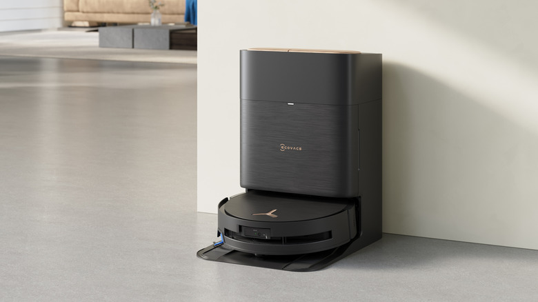 An ECOVACS brand floor cleaner and dock on a concrete floor