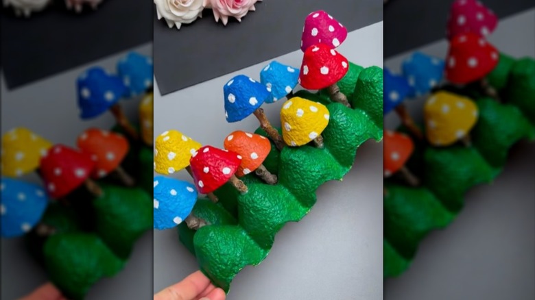A painted mushroom display made from an egg carton