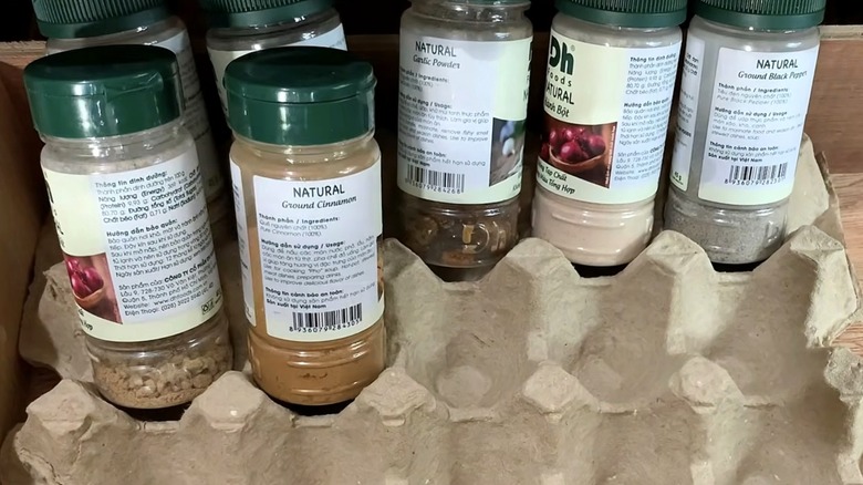 Spice containers organized in a DIY egg carton spice tray