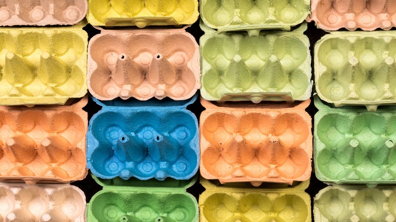Rows of empty egg cartons of different colors