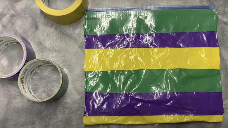 Rolls of tape sit next to a colorful DIY striped storage pouch