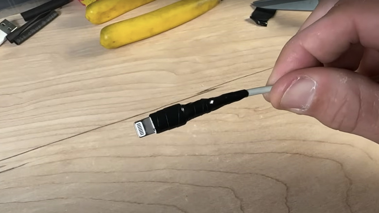 Black electrical tape is wrapped around a broken phone charger